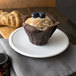 A blueberry muffin and a croissant on a Libbey Alpine White porcelain coupe plate.