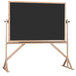 A black board with a wooden frame on a stand.