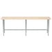 An Advance Tabco wood top work table with a galvanized metal base.