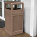 A brown Commercial Zone PolyTec waste container on a porch.