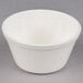 a white bowl on a gray surface