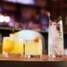 A group of Chef & Sommelier Cabernet Rocks Glasses filled with cocktails on a table.