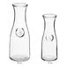 Two Acopa clear glass carafes.