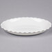 A white rectangular dish with a scalloped edge.