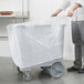 A person holding a vinyl cover over a Cambro dish caddy.