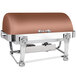 An Eastern Tabletop rectangular copper chafing dish with a lion head lid on a table.
