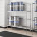 A Regency chrome metal keg rack holding six kegs.