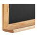 A black slate chalkboard with a black solid oak wood frame.