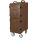 A brown Carlisle Cateraide front loading insulated food pan carrier with black handles and wheels.