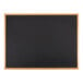 A black chalkboard with a black solid oak wood frame.