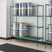 A Regency green metal keg rack holding six beer kegs.