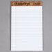 A white TOPS legal pad with narrow ruled paper.