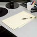 A desk with a TOPS Docket notebook and pens.