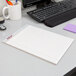 A white desk with a TOPS Prism+ legal pad, pen, and notebook.