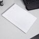 A TOPS Docket Gold spiral bound planner pad on a desk.