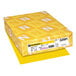 A yellow package of Sunburst Yellow Astrobrights paper with white and yellow designs.