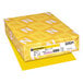 A yellow package of Astrobrights Solar Yellow color paper with white and yellow designs.