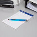 A pen on a stack of Ampad College Ruled Writing Pads
