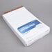 A stack of TOPS white wide ruled legal writing pads.