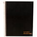 A black wirebound planner with gold spiral binding and orange writing on the cover.