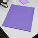 An Oxford purple embossed paper pocket folder on a white surface.