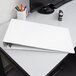 A white Cardinal tabloid size binder with a computer on a desk.
