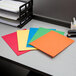 A desk with several Oxford 2-pocket folders in assorted colors.