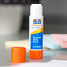 An orange Elmer's all-purpose glue stick on a table.