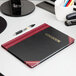 A black Boorum & Pease log book with red accents.