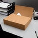 A stack of brown folders on a desk.