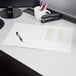 A white Oxford 2-pocket folder on a desk with a pen and stapler.