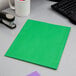 A light green Oxford paper pocket folder on a desk.