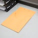 A yellow Pendaflex classification pocket on a desk.