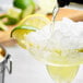 A Twang-a-Rita margarita with lemon-lime rim salt being poured in a glass.