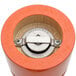 A close up of a Chef Specialties Butternut Orange pepper and salt mill set.