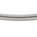 A close-up of Equip by T&S stainless steel flexible hose with a spiral wire.