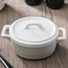 A white porcelain Bon Chef oval casserole with a lid.