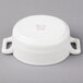 A white porcelain oval cocotte with handles.
