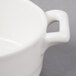 A close-up of a white Bon Chef oval cocotte with a handle.