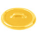 A yellow Bon Chef porcelain oval lid with a handle.