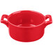 A red porcelain cocotte with two handles.