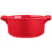 A red porcelain cocotte with handles.