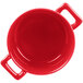 A red porcelain cocotte with two handles.