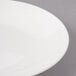 A close-up of a Bon Chef white porcelain bread and butter plate with a thin rim.