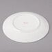 A white Bon Chef porcelain bread and butter plate with circles on it.