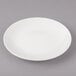 A white Bon Chef porcelain bread and butter plate with a rim.