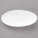A white slanted oval porcelain bowl.