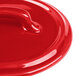 A red Bon Chef porcelain lid with a handle.