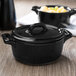 A matte black Bon Chef oval cocotte lid.