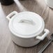 A white Bon Chef porcelain cocotte with a lid.